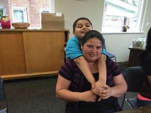 Maria, a worker at Churchill Downs in Louisville, KY, with her son, Angel, at the Backside Learning Center.