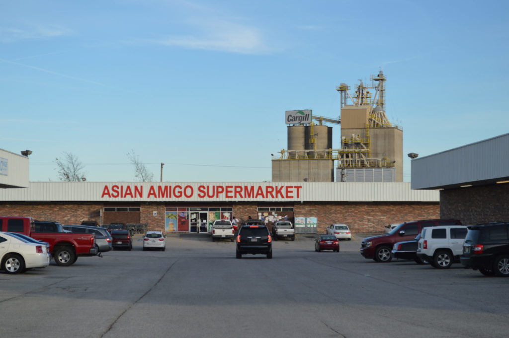 The Cargill plant is visible behind Asian Amigo Supermarket, an international grocery in Springdale.
