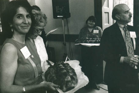 Food scholar Marcie Cohen Ferris (left) holds a tray of traditional braided challah, while Macy Hart (right), President/CEO of the Goldring/Woldenberg Institute for Southern Jewish Life, watches the proceedings of the 1994 Homecoming. (Photo by Gretchen Haien)