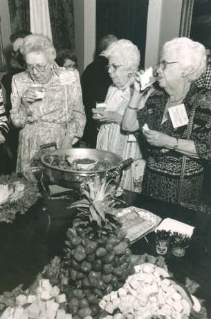 Attendees of the Natchez Jewish Homecoming circle a buffet table at Stanton Hall. The menu featured a mix of Jewish and Southern dishes, some kosher and some treif, including the infamous ham biscuits. (Photo by Gretchen Haien) 